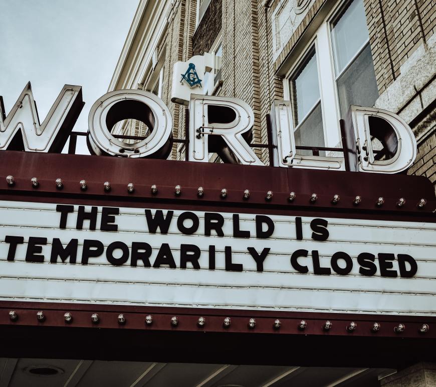 world theater marquee sign that reads "the world is temporarily closed"