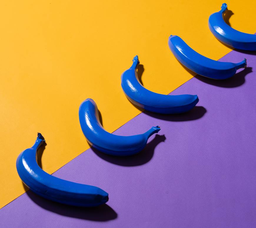 5 blue bananas on a yellow and blue background
