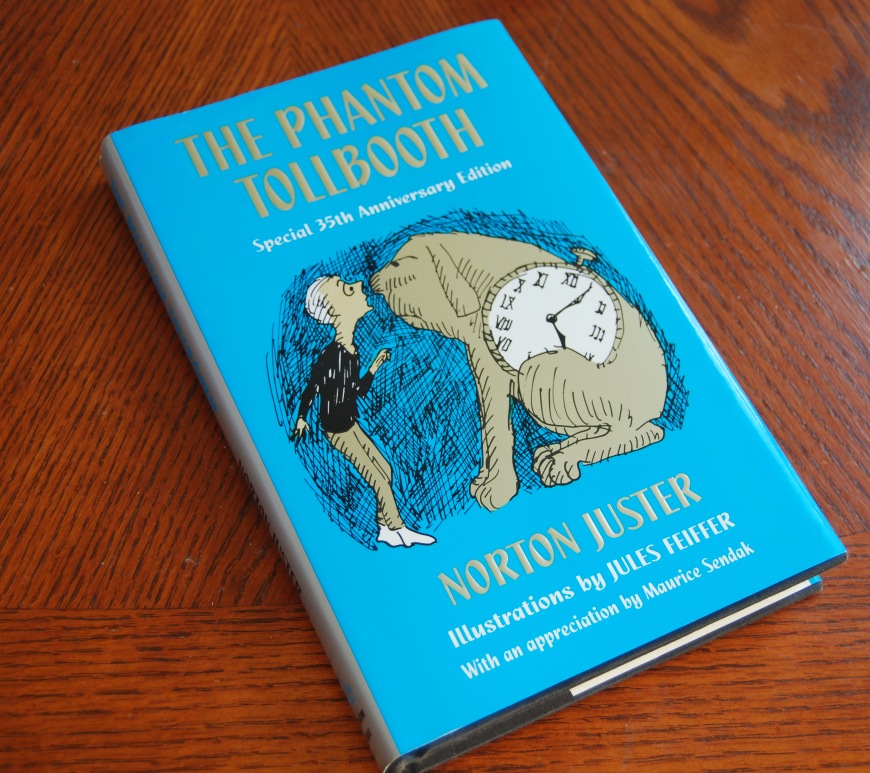 phantom tollbooth book on a wooden surface