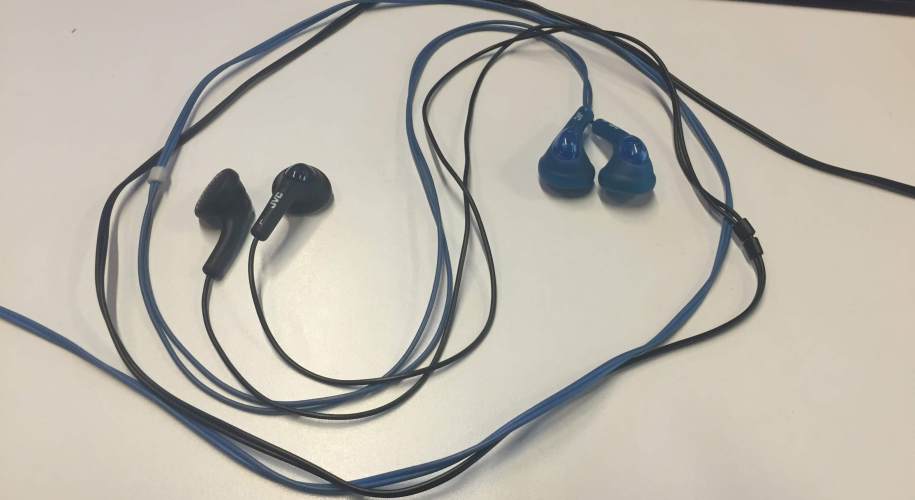 yin yang symbol made with blue and black earbuds