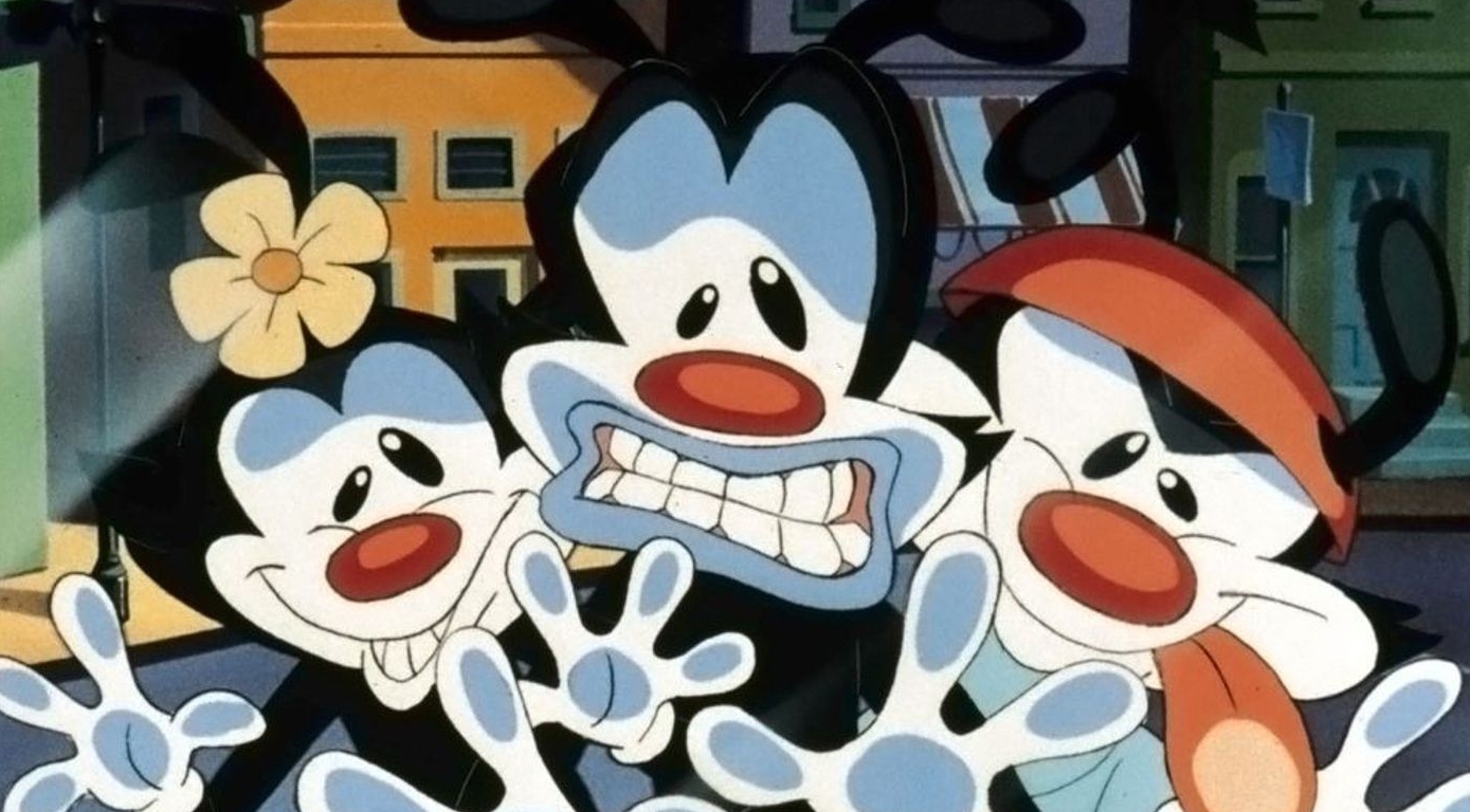 image from the show animaniacs where yakko, wacko, and dot have their faces smushed against the glass