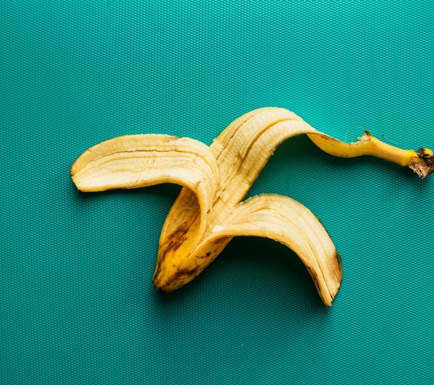 old banana peel on a teal background