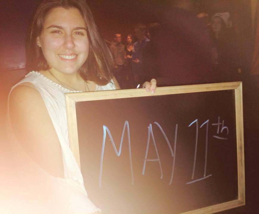 image of renata smiling and holding a chalkboard that reads "may 11th"
