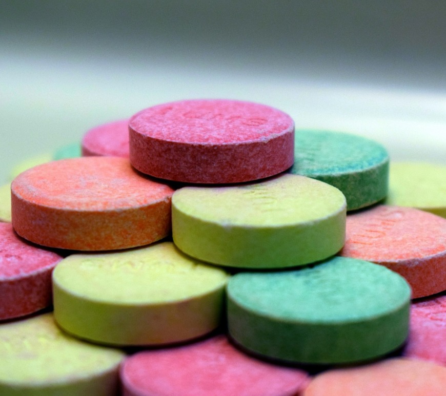 stack of multicolored tums antacid tablets